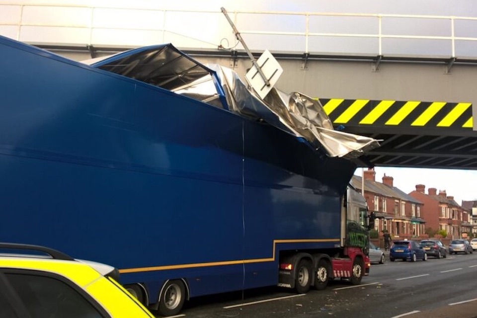 articulated lorry damaged and stuck under railway bridge