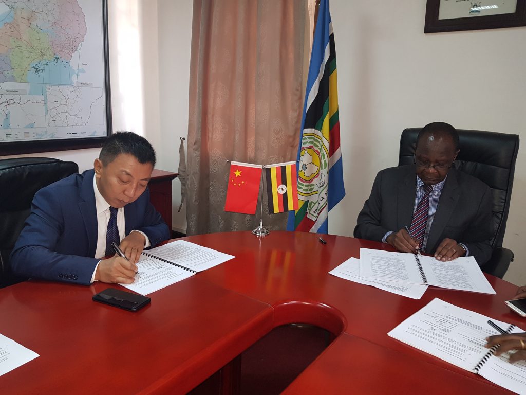 Jingjun Li, CEO of CHEC, and Waiswa Bageya, Permanent Secretary of the ministry of Works and Transport, signing the deal in 2019